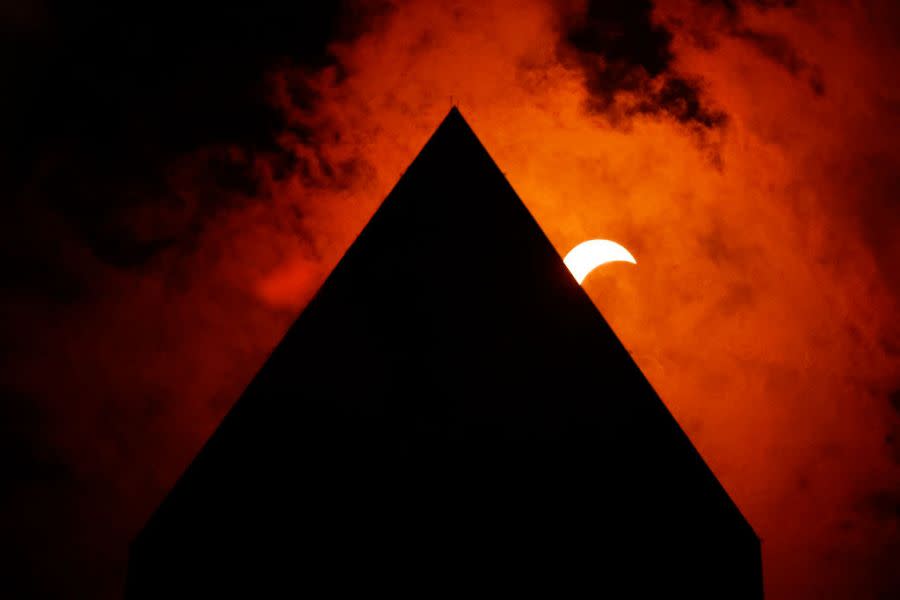 The solar eclipse is seen above the Washington Monument on April 08, 2024 in Washington, DC. People have traveled to areas across North America that are in the “path of totality” in order to experience the eclipse today. The next total solar eclipse that can be seen from a large part of North America won’t happen until 2044. (Photo by Chip Somodevilla/Getty Images)