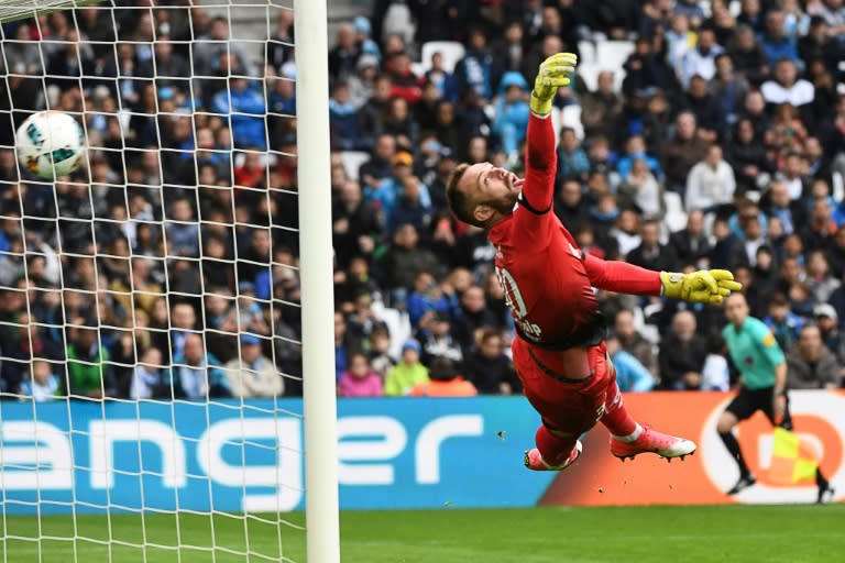 Dijon's Baptiste Reynet fails to stop a shot by Marseille's Dimitri Payet during their match at the Velodrome stadium in Marseille on April 1, 2017