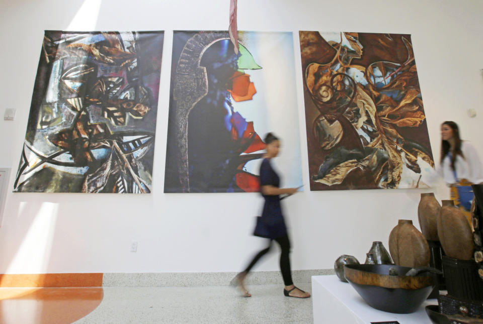 Visitors check art, furnishing and accessories at the Discover Haiti Exhibition in the Little Haiti area of Miami, Friday, May 17, 2013. (AP Photo/Alan Diaz)