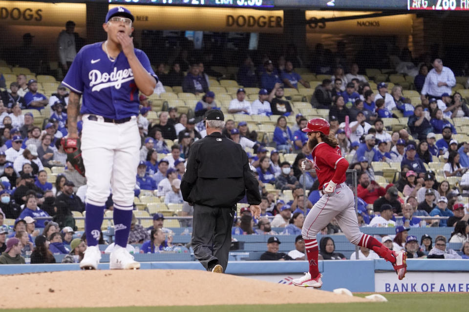 Los Angeles Angels' Brandon Marsh, right, rounds third after hitting a solo home run as Los Angeles Dodgers starting pitcher Julio Urias stands on the mound during the third inning of a spring training baseball game Monday, April 4, 2022, in Los Angeles. (AP Photo/Mark J. Terrill)
