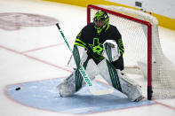 Dallas Stars goaltender Jake Oettinger (29) warms up before an NHL hockey game against the Chicago Blackhawks, Sunday, Feb. 7, 2021, in Dallas. (AP Photo/Sam Hodde)