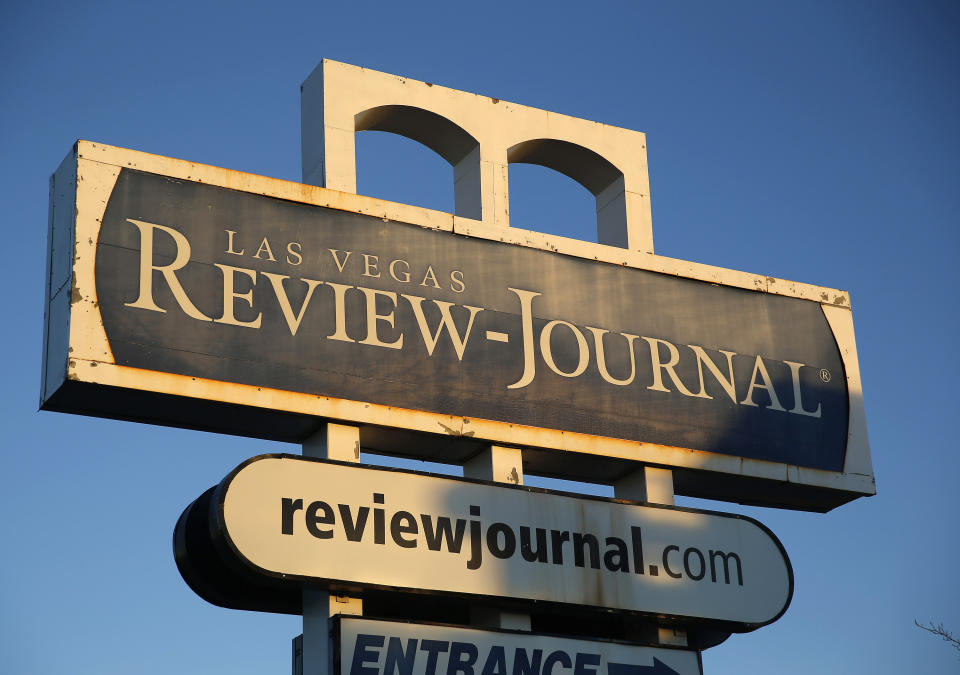 FILE - This Dec. 17, 2015 file photo shows a sign outside the building housing the Las Vegas Review-Journal in Las Vegas. A Nevada judge has upheld an arbitrator's finding in a hard-fought legal battle, ruling that the Review-Journal, the dominant newspaper in Las Vegas, has to submit to an audit and pay its crosstown rival and joint-operating agreement partner, the Las Vegas Sun, expenses that have been withheld in recent years. (AP Photo/John Locher, File)