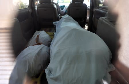 The bodies of Oscar Alberto Martinez Ramirez and his daughter Valeria, migrants who drowned in the Rio Grande river during their journey to the U.S., are seen through the window of a hearse in Matamoros