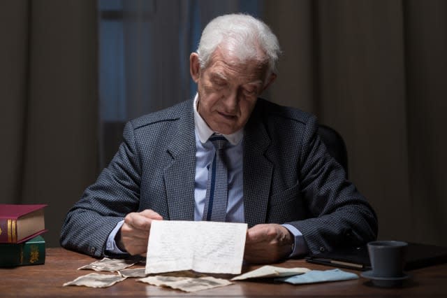 Older man checking paperwork