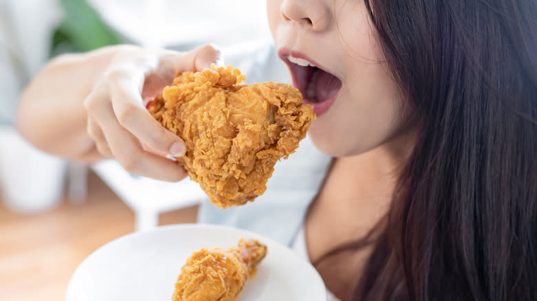 Woman eating fried chicken