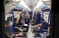 London Underground passengers, some wearing masks, travel amidst the spread of the coronavirus disease (COVID-19) pandemic, in London