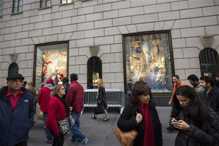 Pedestrians walk past holiday windows at the Bergdorf Goodman store in New York, November 22, 2013. REUTERS/Lucas Jackson