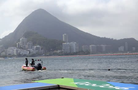 2016 Rio Olympics - Rowing - Repechage - Men's Single Sculls Repechages - Lagoa Stadium - Rio De Janeiro, Brazil - 07/08/2016. A patrol boat travels on the course at Lagoa Stadium after competition was postponed. REUTERS/Murad Sezer