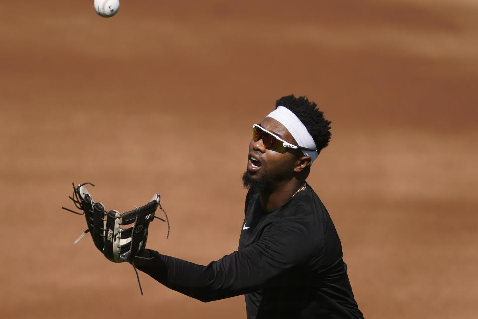 Chicago White Sox's Eloy Jimenez catches a ball at practice during a baseball workout in Oakland, Calif., Monday, Sept. 28, 2020. The White Sox are scheduled to play the Oakland Athletics in an American League wild-card playoff series starting Tuesday. (AP Photo/Jeff Chiu)