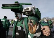 David and Robyn Klassen sport hats depicting a western Canada grain farming theme outside the stadium prior to the 101st Grey Cup championship football game in Regina, Saskatchewan November 24, 2013. REUTERS/Todd Korol (CANADA - Tags: SPORT FOOTBALL)