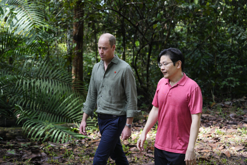 Britain's Prince William, left, and Singapore's Deputy Prime Minister and Minister of Finance Lawrence Wong visit the Central Catchment Nature Reserve of Singapore, Wednesday, Nov. 8, 2023. (AP Photo/Vincent Thian)