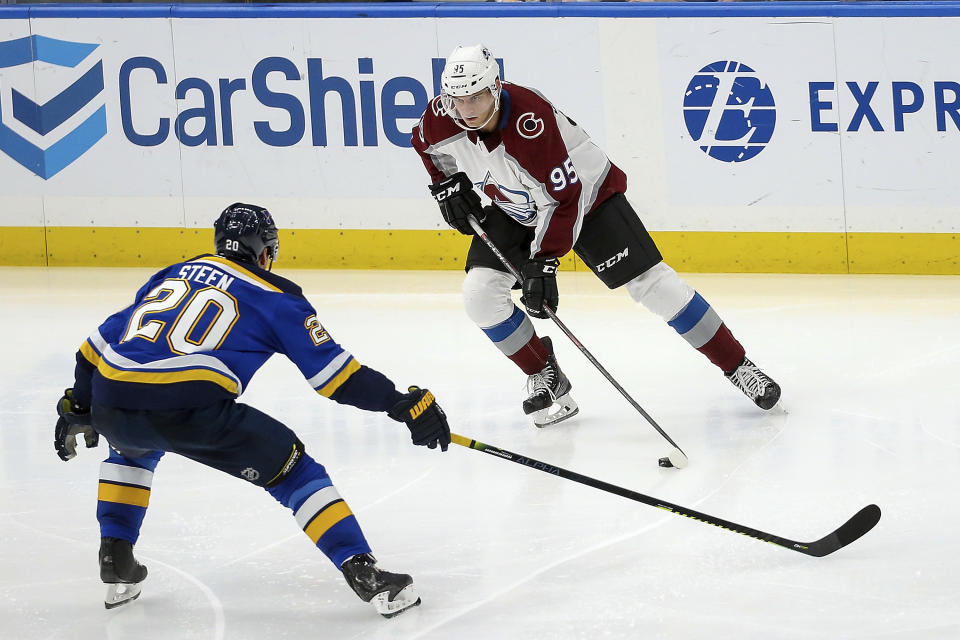 Colorado Avalanche's Andre Burakovsky (95), of Austria, handles the puck as St. Louis Blues' Alexander Steen (20) defends during the third period of an NHL hockey game Monday, Oct. 21, 2019, in St. Louis. (AP Photo/Scott Kane)
