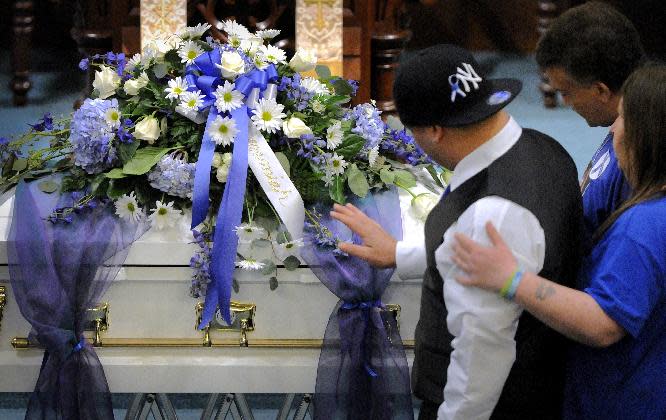 Reaching out to his son's casket, Jose Oliver, father of five-year-old Jeremiah Oliver, is comforted by his brother Sandrino Oliver and another mourner during the visiting hours before his son's funeral at Rollstone Congregational Church in Fitchburg, Mass., on Saturday, May 3, 2014. Jeremiah Oliver is the 5-year-old Fitchburg boy who disappeared in September 2013 and was found dead along Interstate 190 in Sterling, Mass., in April. (AP Photo/Worcester Telegram & Gazette, Paul Kapteyn)