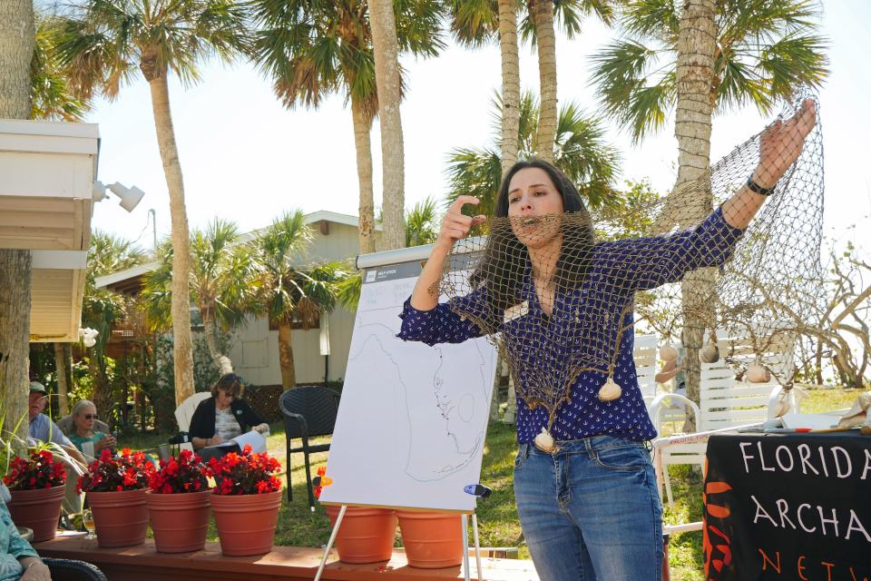 Rachael Kangas, director of west central and central regions for the Florida Public Archaeology Network, shows an audience at the Manasota Beach Club Monthly Lecture Series a cast net similar to one found preserved in muck at the Key Marco archaeological site.