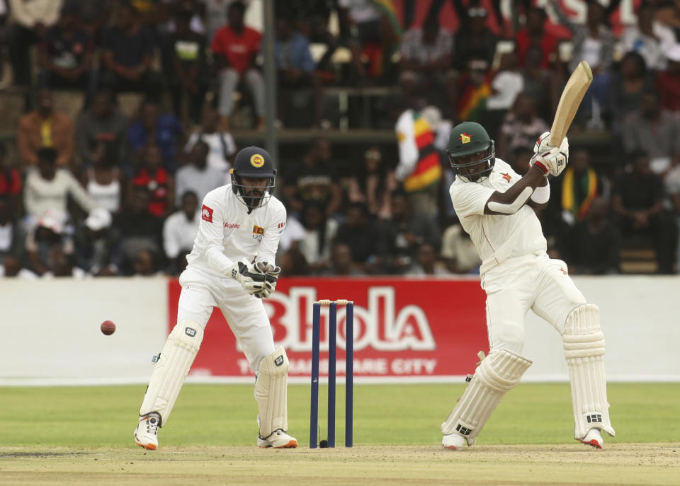 Zimbabwe batsman Kevin Kasuza, right, plays a shot during the test cricket match against Sri Lanka at Harare Sports Club, Sunday, Jan, 19, 2020. Zimbabwe won the toss and elected to bat in its first match since the International Cricket Council lifted the country's ban last year. (AP Photo/Tsvangirayi Mukwazhi)