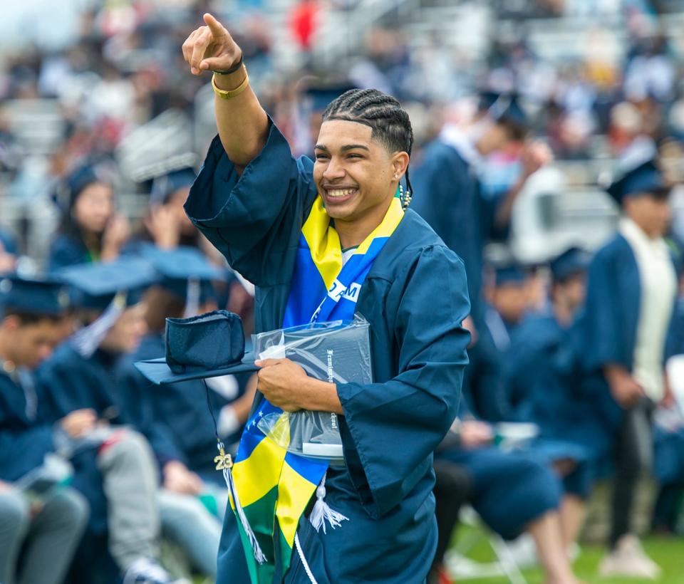 Framingham High School graduate Quemuel Pires is all smiles after receiving his diploma during Sunday's graduation ceremony at Bowditch Field, June 4, 2023.