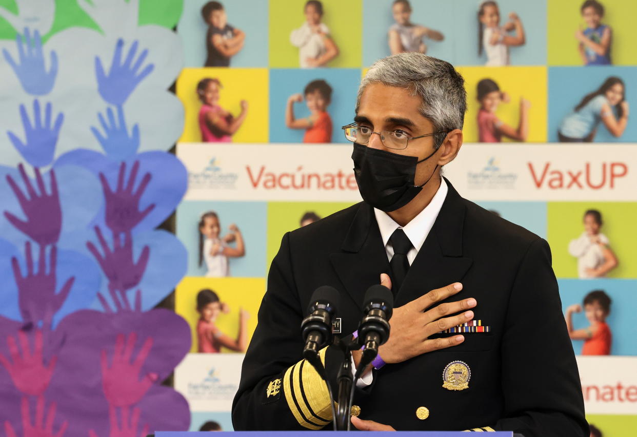 Dr. Vivek Murthy stands at a podium with microphones.