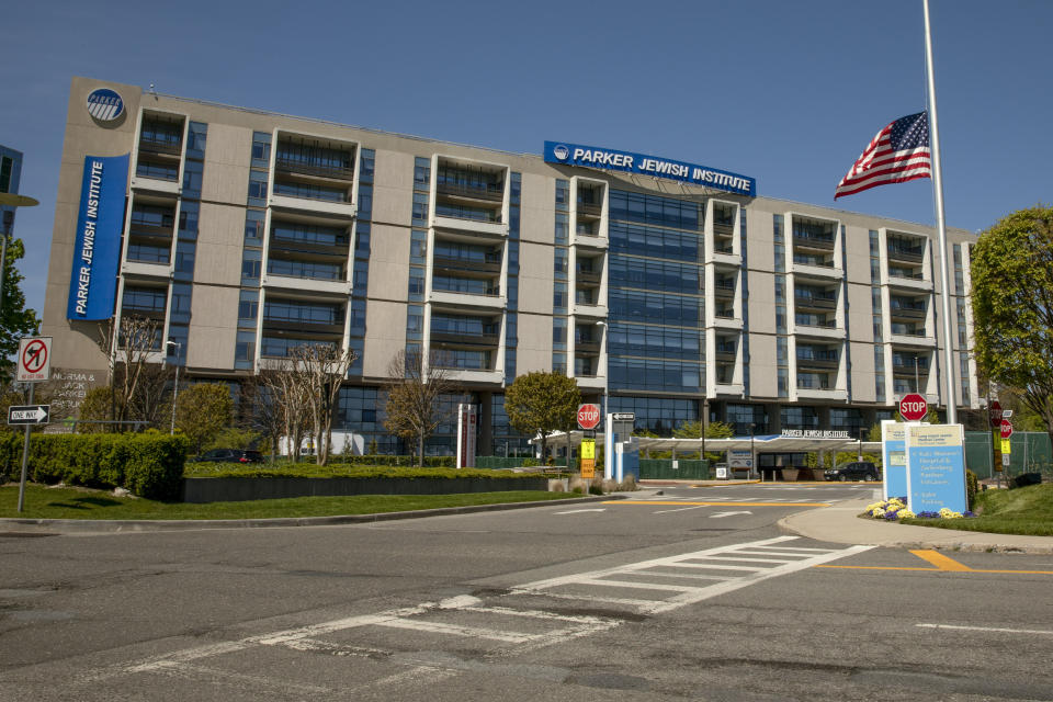 A flag flies at half staff outside the Parker Jewish Institute for Healthcare and Rehabilitation, Monday, May 4, 2020, in the Queens borough of New York. New York state is reporting more than 1,700 previously undisclosed deaths at nursing homes and adult care facilities as the state faces scrutiny over how it's protected vulnerable residents during the coronavirus pandemic. Parker Jewish Institute reported the highest number of deaths: 71.(AP Photo/Marshall Ritzel)