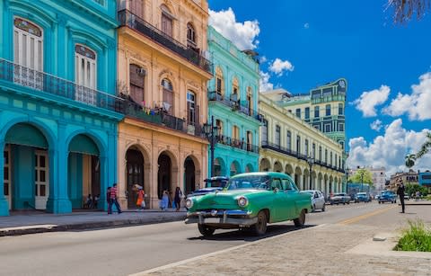 Vintage cars and colourful buildings in Havana - Credit: iStock