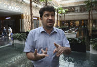 Ali Momeni, a 37-year-old accountant, speaks with The Associated Press about a presidential election that many fear will only underscore their powerlessness to shape the country's fate, at Tehran Mall shopping center, in Tehran, Iran, Wednesday, June 9, 2021. “Rouhani’s administration was full of disappointment and incompetence. I deal with finances because of my job and have witnessed the adversity facing our citizens everyday,” said Momeni. (AP Photo/Vahid Salemi)