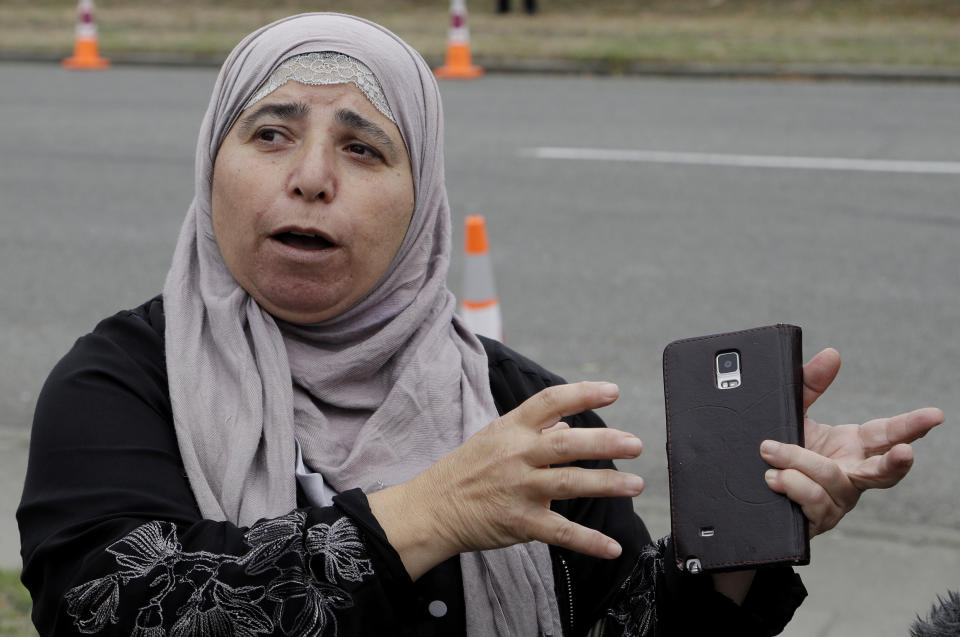 FILE - In this March 18, 2019, file photo, Al Noor mosque shooting survivor Kawthar Abulaban gestures as she explains escaping from the mosque to media in Christchurch, New Zealand. Abulaban was in the women’s prayer area with other women. She heard a single shot at first, enough for some of them to jump up and say, “What’s wrong?” Then there was a pause and a second shot and a dawning realization. Soon, there was a barrage of bullets. (AP Photo/Mark Baker, File)