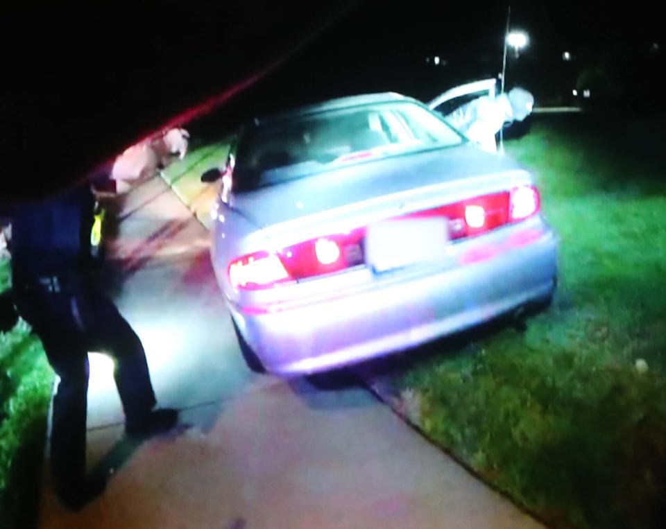 This still image from a police bodycam, which shows Jayland Walker wearing a ski mask and running out of his car, was presented during a press conference Sunday at the Firestone Community Center in Akron.