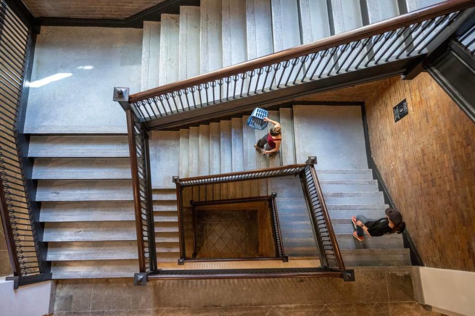 Tenants walk down the staircase at The Residences at Park 39 on Thursday, May 9, 2024, in Kansas City.