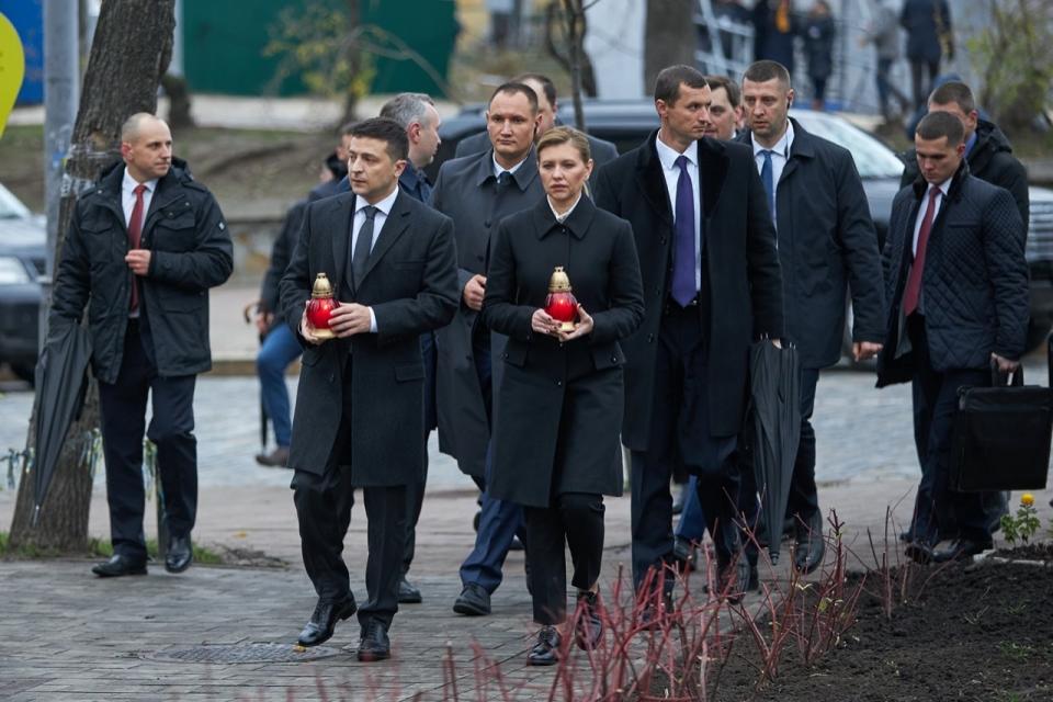 Ukrainian President Volodymyr Zelenskiy, foreground left, and his wife Olena Zelenska hold candles as they walk to a memorial in Independent Square (Maidan) in Kyiv, Ukraine, Thursday, Nov. 21, 2019. The memorial is dedicated to people who died in clashes with security forces in 2013 during protests sparked by then President Viktor Yanukovych’s decision in November 2013 to freeze ties with the West and tilt toward Moscow. (Ukrainian Presidential Press Office via AP)
