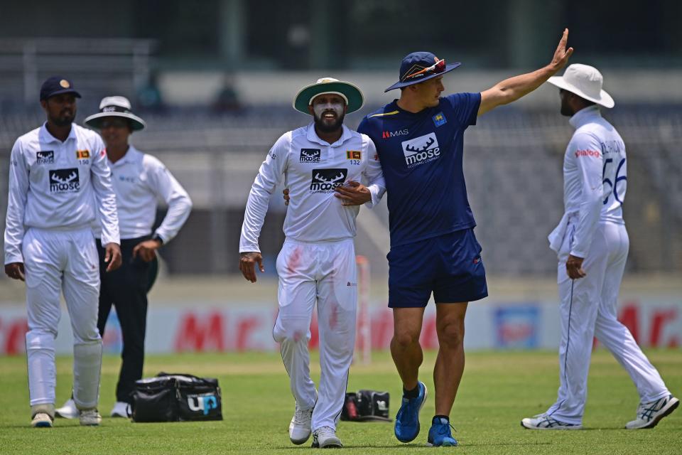 Kusal Mendis, pictured here walking from the field holding his chest.