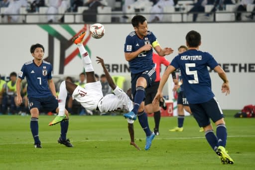 Qatar's forward Almoez Ali (C) shoots to score during the 2019 AFC Asian Cup final football match between Japan and Qatar at the Zayed Sports City Stadium in Abu Dhabi on February 1, 2019