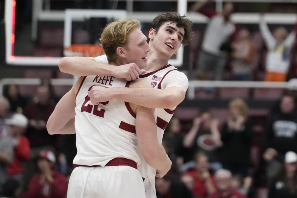 Stanford forward Maxime Raynaud, right, hugs forward James Keefe (22) after a win over Utah in an NCAA college basketball game, Sunday, Jan. 14, 2024, in Stanford, Calif. | Godofredo A. Vásquez, Associated Press