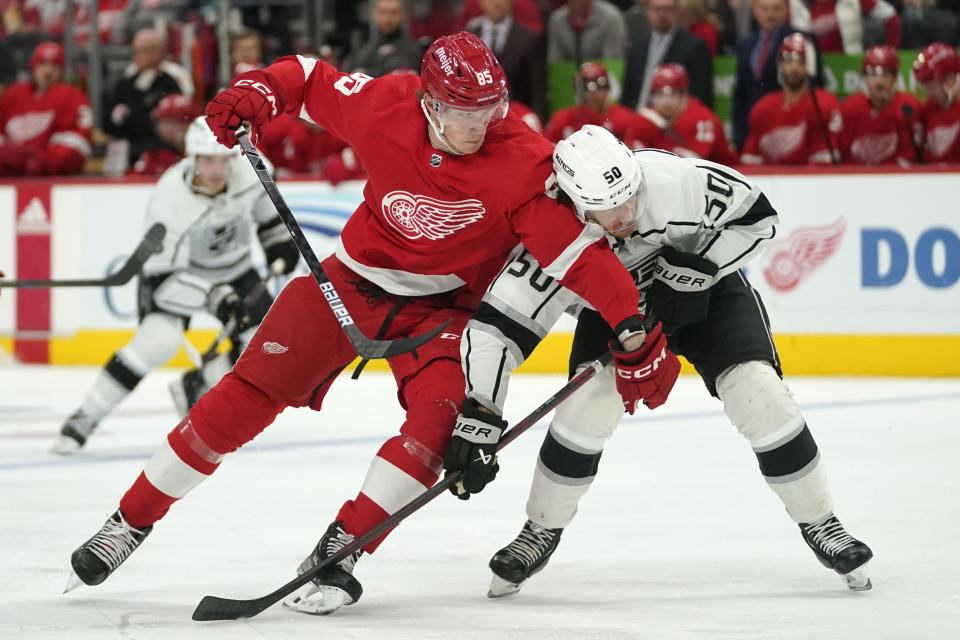 Detroit Red Wings left wing Elmer Soderblom (85) and Los Angeles Kings defenseman Sean Durzi (50) battle for the puck in the second period of an NHL hockey game Monday, Oct. 17, 2022, in Detroit. (AP Photo/Paul Sancya)