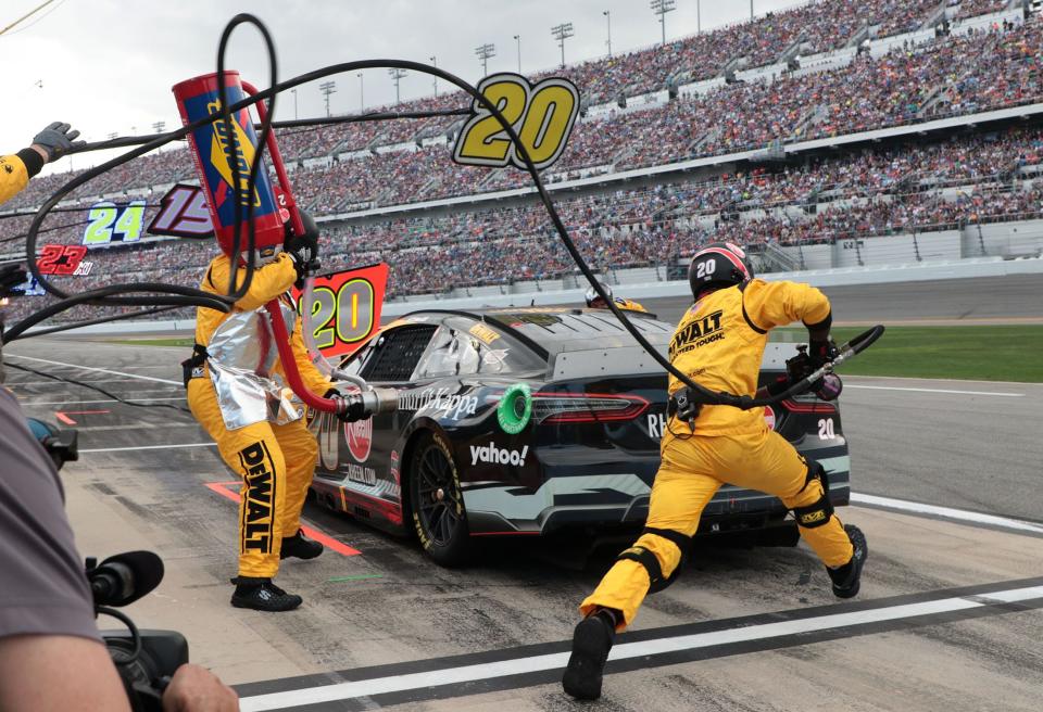 Pit crew members jump intro action to service Christopher Bell's No. 20 Toyota during last year's Daytona 500 at Daytona International Speedway. According to early forecasts, there could be clouds and a chance of rain for this year's Daytona 500 on Feb. 18 in Daytona Beach.