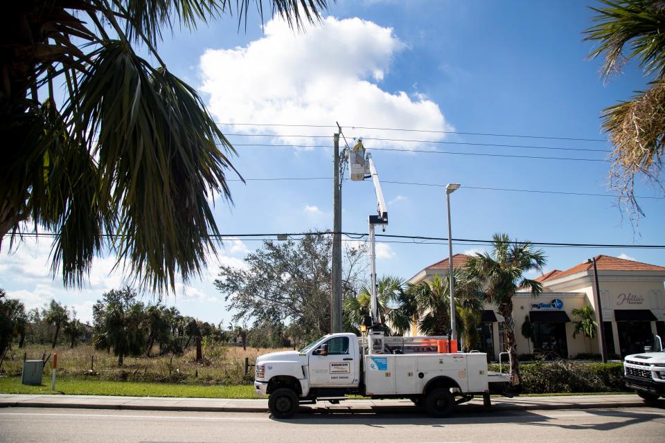 A lineman from the FPL Emergency Response Team works on a powerline on Gladiolus Drive on Saturday, Oct. 1, 2022, in south Fort Myers.