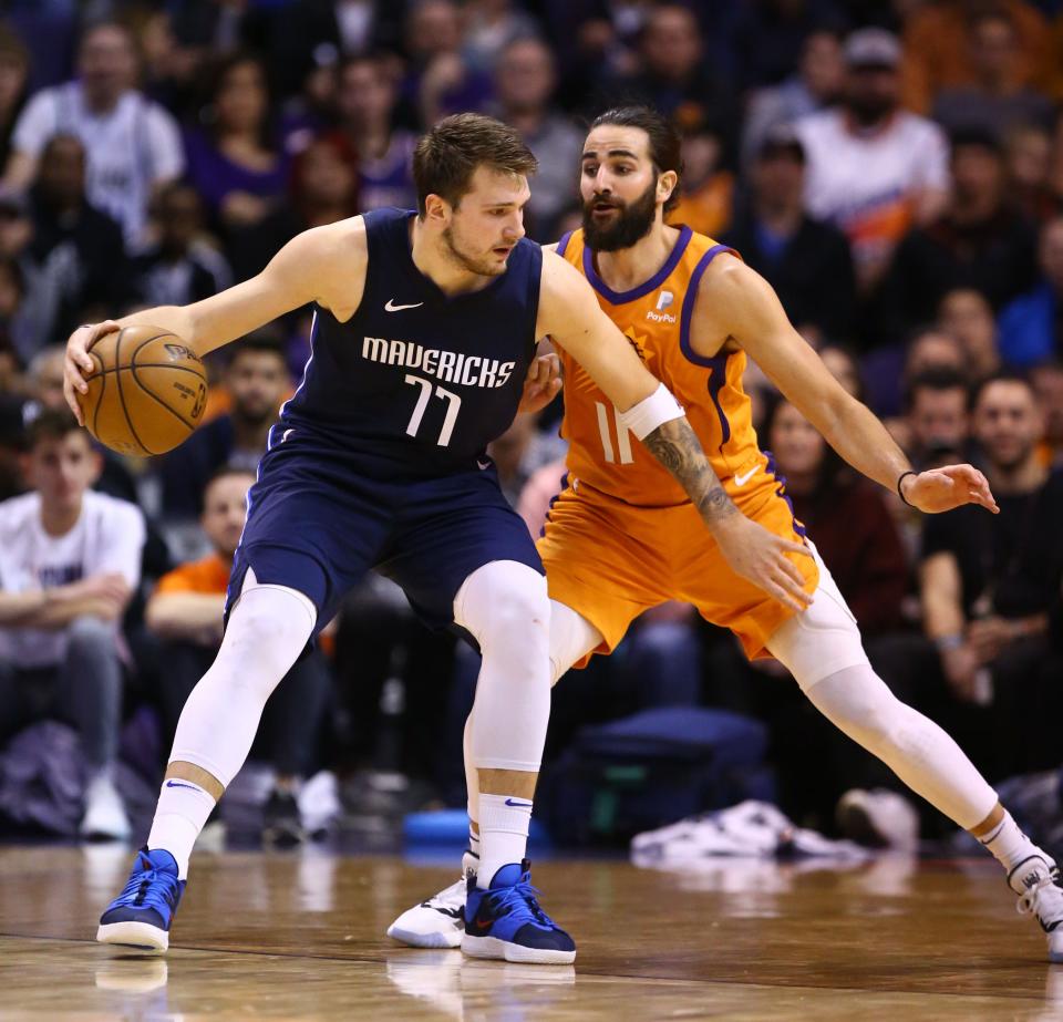 Dallas Mavericks forward Luka Doncic (77) is pressured by Phoenix Suns guard Ricky Rubio (11) in the second half on Nov. 29, 2019 in Phoenix, Ariz.