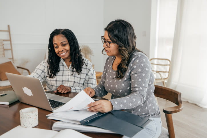 Two financial advisors discussing a specific client's portfolio