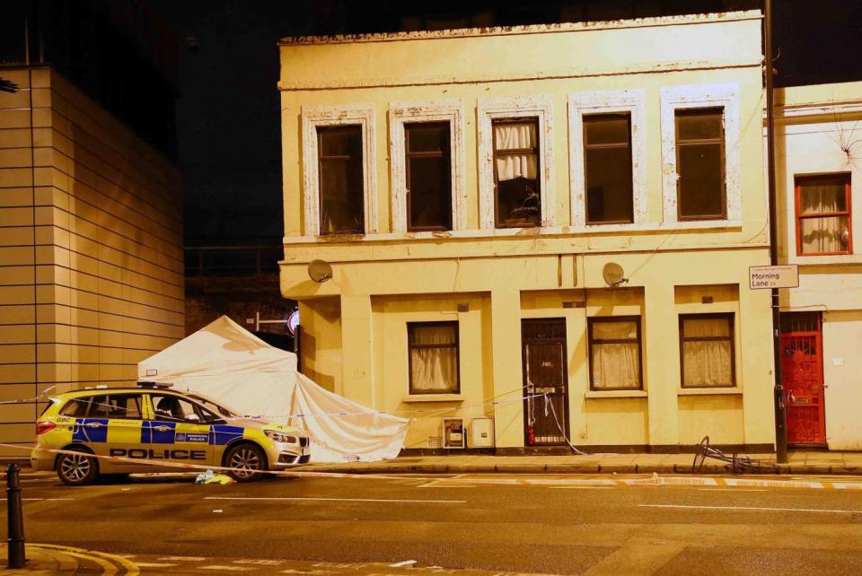 Scene: police erected a forensic tent in Link Street, Homerton, where Israel Ogunsola died of stab wounds (NIGEL HOWARD)