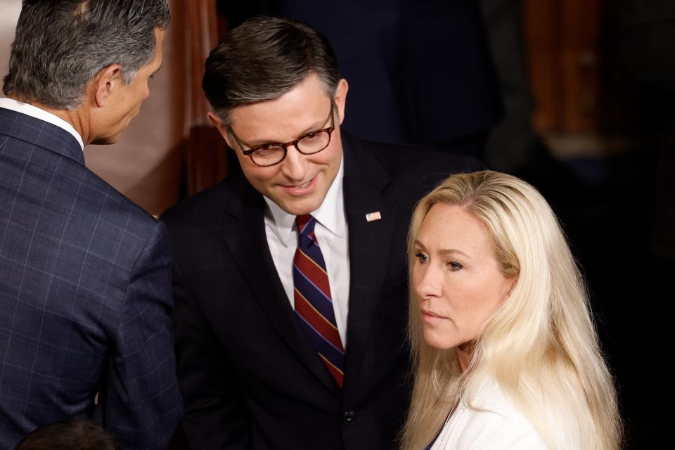 Speaker of the House Mike Johnson (left) and Representative Marjorie Taylor Greene (right) pictured speak to one another in the US Capitol in April. Ms Greene vowed to force a vote on Mr Johnson’s removal this week (Getty Images)