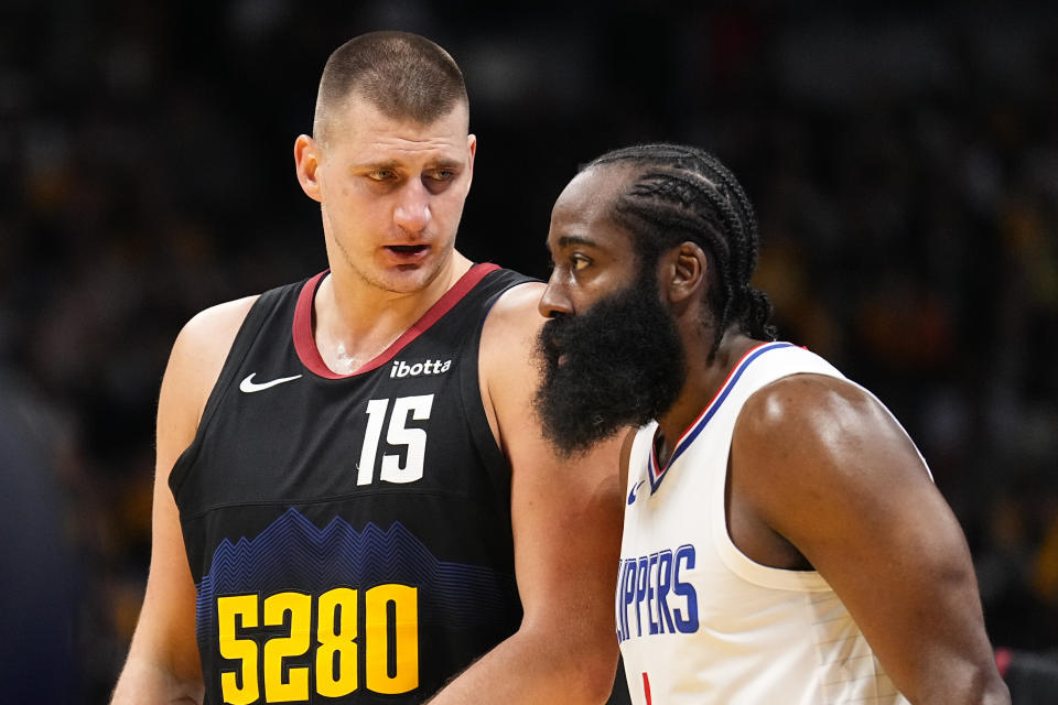 Denver Nuggets center Nikola Jokic (15) talks with Los Angeles Clippers guard James Harden (1) during the first half of an NBA basketball in-season tournament game Tuesday, Nov. 14, 2023, in Denver. (AP Photo/Jack Dempsey)