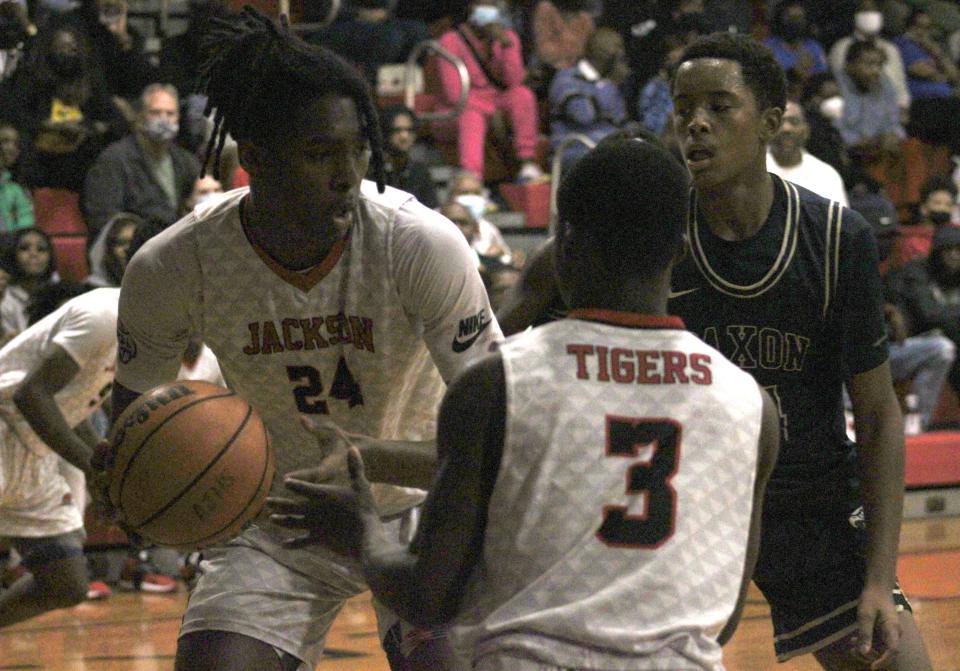 Jackson center Stephon Payne (24) pulls down a rebound during the Gateway Conference high school boys basketball final against Paxon.