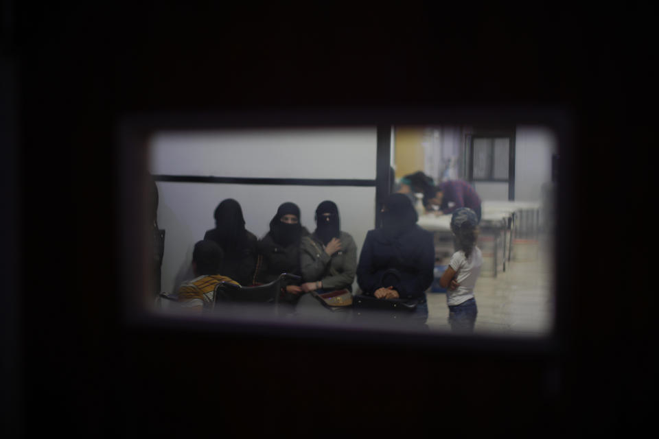 In this July 15, 2018 photo, Syrian women wait in an underground hospital that insurgents referred to as Point One, in Douma, near the Syrian capital Damascus, Syria. The fate of activist Razan Zaitouneh is one of the longest-running mysteries of Syria’s civil war. There’s been no sign of life, no proof of death since gunmen abducted her and three of her colleagues from her offices in the rebel-held town of Douma in 2013. Now Douma is in government hands and clues have emerged that may bring answers. (AP Photo/Hassan Ammar)