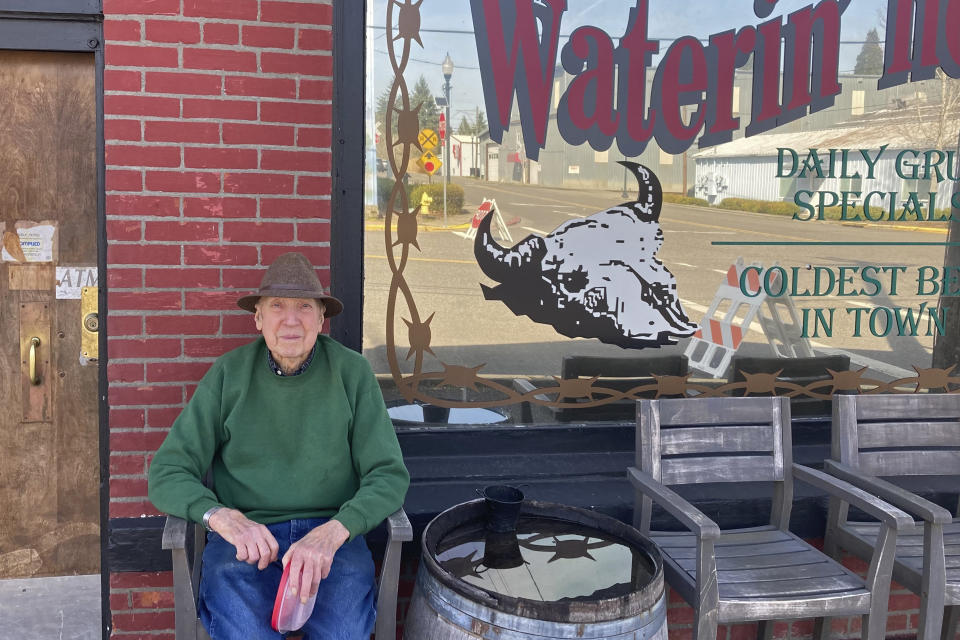 Melvin Van Donelen, 91, sits outside a restaurant in the small town of North Plains, Ore., on March 17, 2023. Van Donelen said he doesn't like to see development come to his small town near Portland, Ore., but believes it is inevitable. Semiconductor businesses might be cropping up nearby before long if state officials are able to provide incentives for them, including setting aside land to build on. (AP Photo/Andrew Selsky)