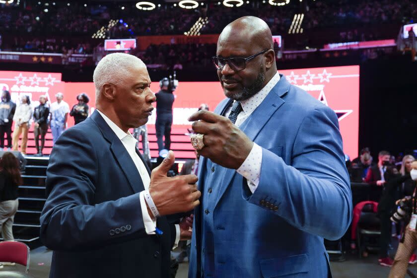 Former NBA stars Julius Irving, left, and Shaquille O & # 39;  Neil speaks courtside during a skills challenge contest, part of the NBA All-Star Game weekend, Saturday, February 19, 2022, in Cleveland.  (AP Photo/Charles Krupa)