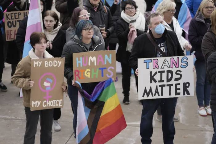 people with posters protest anti-grans legislation at a rally in utah