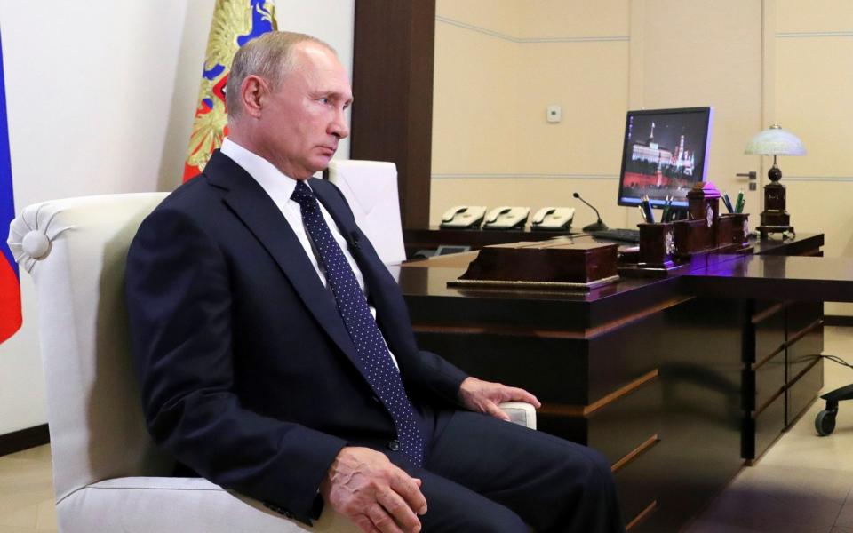 Putin listens to a question during his interview with TV channel 'Russia' - Pool Sputnik Kremlin