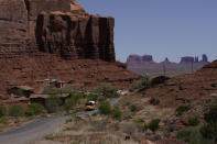 In this April 27, 2020, photo, a school bus is driven through Oljato-Monument Valley, Utah, on the Navajo reservation. Even before the pandemic, people living in rural communities and on reservations were among the toughest groups to count in the 2020 census. (AP Photo/Carolyn Kaster)
