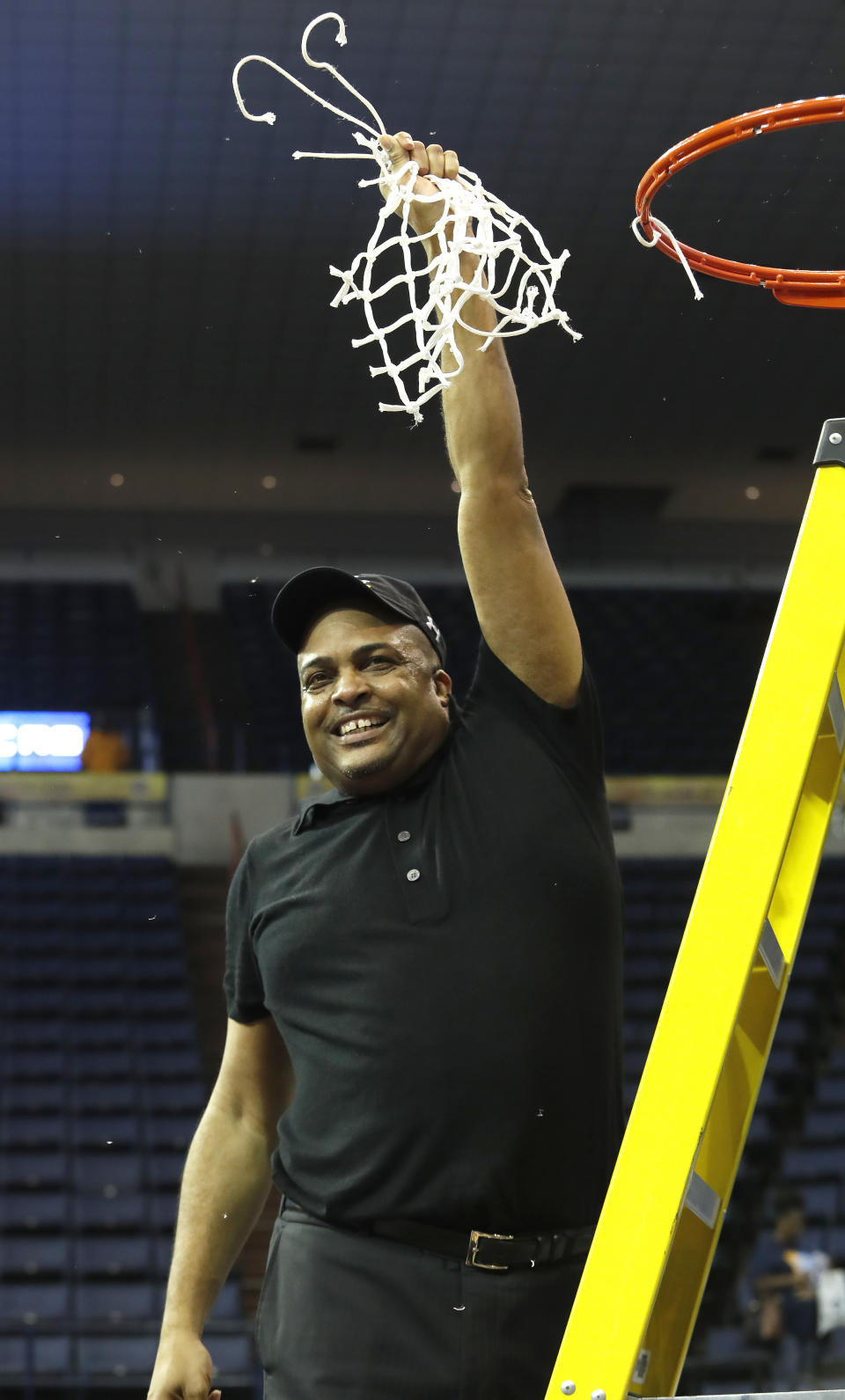 Georgia State head coach Ron Hunter holds a piece of the net after playing Texas-Arlington in the NCAA college basketball championship game of the Sun Belt Conference men's tournament in New Orleans, Sunday, March 17, 2019. Georgia State won 73-64. (AP Photo/Tyler Kaufman)