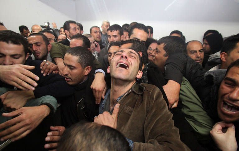 Palestinian relatives and friends mourn the death of Arafat Jaradat, who died in an Israeli prison, after his body was handed over by Israeli authorities on February 24, 2013, at a hospital in the West Bank city of Hebron. A Palestinian official charged on Sunday that Jaradat was tortured to death, dismissing Israeli accounts of an apparent heart attack