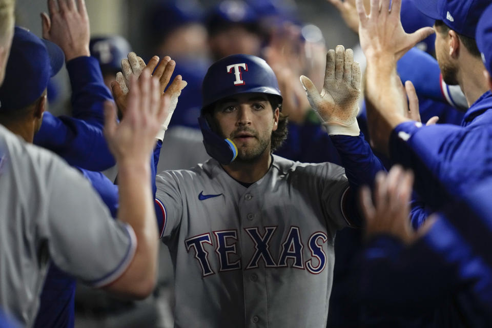 Texas Rangers' Josh Smith (47) celebrates in the dugout after hitting a home run during the ninth inning of a baseball game against the Los Angeles Angels in Anaheim, Calif., Tuesday, Sept. 26, 2023. Austin Hedges also scored. (AP Photo/Ashley Landis)