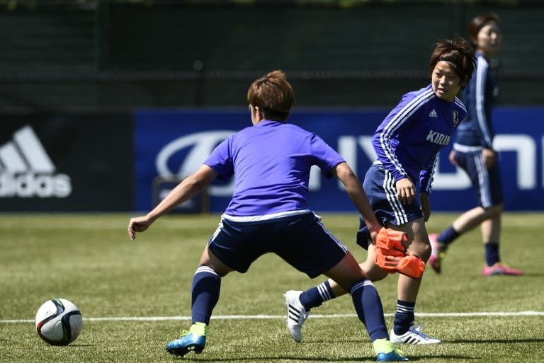 Japan's captain Aya Miyama (R) eyes the ball during a training session in Vancouver, British Columbia, on July 4, 2015, on the eve of their FIFA Women's World Cup final against the US